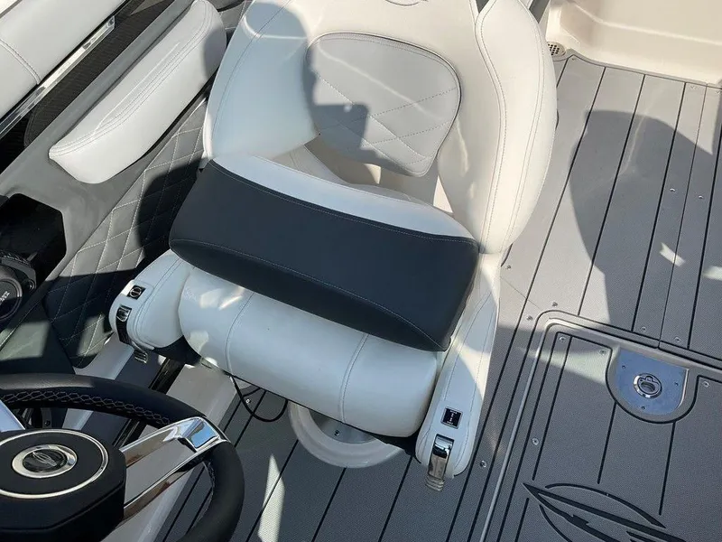 Slide: The Image of 2024 Chaparral 267 SSX boat interior with white and gray seating and steering wheel. - 33