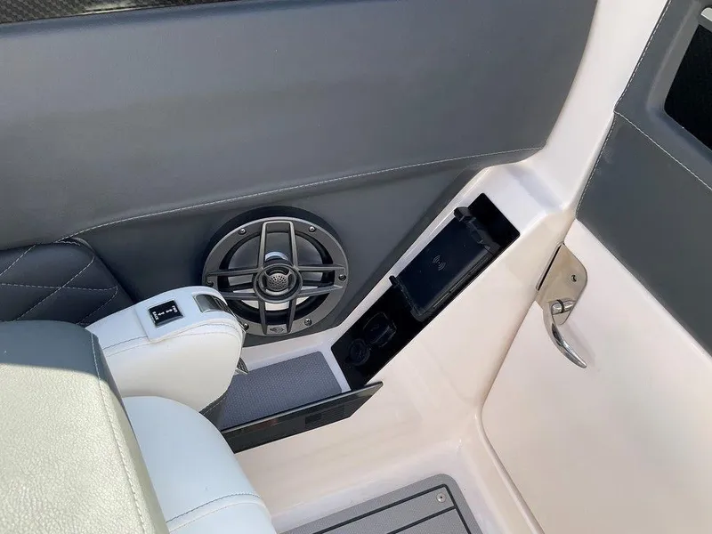 Slide: The Image of Interior of 2024 Chaparral 267 SSX boat, featuring speaker and seating area. - 35