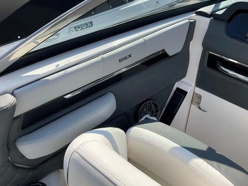 Slide: The Image of 2024 Chaparral 267 SSX interior with sleek white and gray seating. - 36