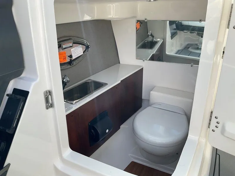 Slide: The Image of 2024 Chaparral 267 SSX boat interior with sink and toilet. - 38