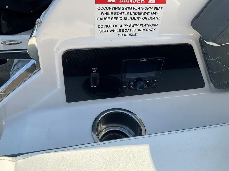 Slide: The Image of 2024 Chaparral 267 SSX boat dashboard with warning label and control panel. - 42