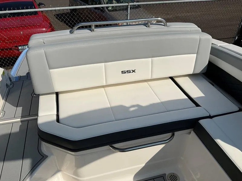 Slide: The Image of 2024 Chaparral 267 SSX boat seating, featuring sleek white and gray upholstery. - 44