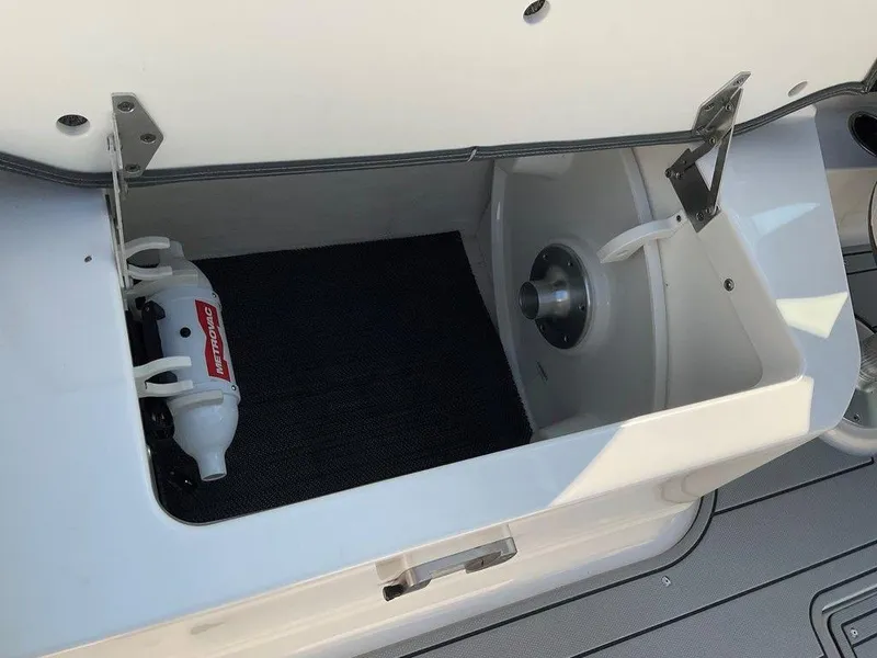 Slide: The Image of 2024 Chaparral 267 SSX storage compartment with fire extinguisher. - 47