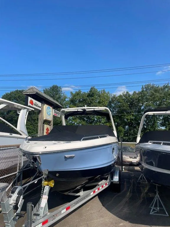 Slide: The Image of 2024 Chaparral 267 SSX boat on trailer under clear blue sky. - 6