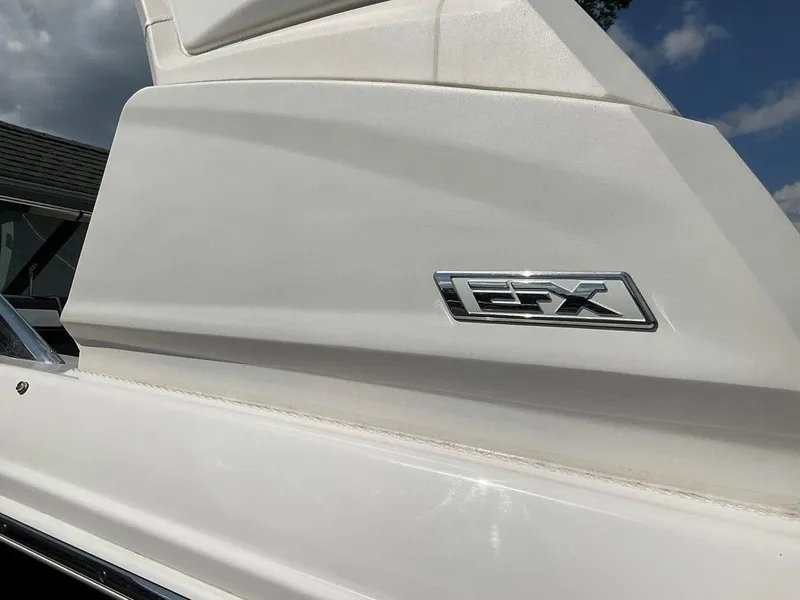 Slide: The Image of 2024 Chaparral 270 OSX boat with FX emblem, white exterior. - 10