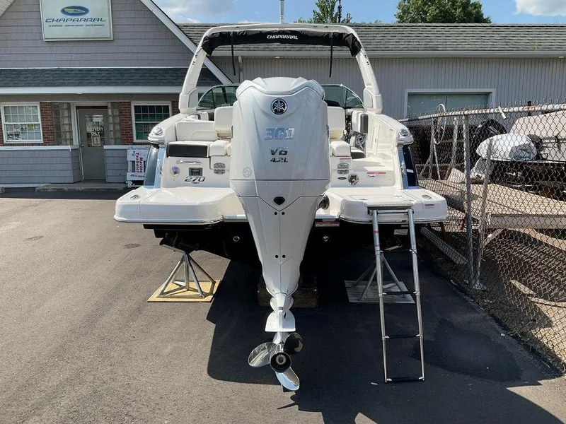 Slide: The Image of 2024 Chaparral 270 OSX boat with Yamaha V6 engine, parked outside dealership. - 11