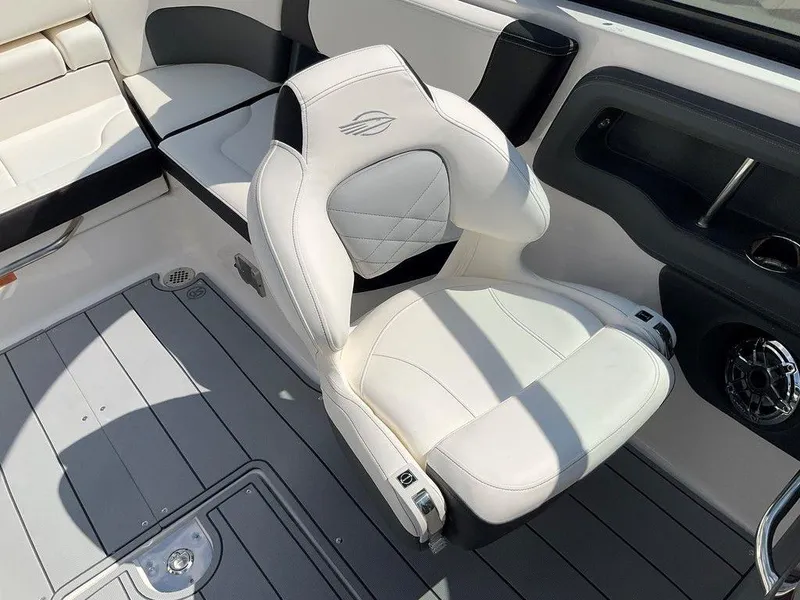 Slide: The Image of 2024 Chaparral 270 OSX boat interior with white cushioned seating and sleek design. - 14