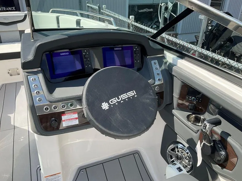 Slide: The Image of 2024 Chaparral 270 OSX boat dashboard with dual Simrad displays and Gussi steering wheel. - 16