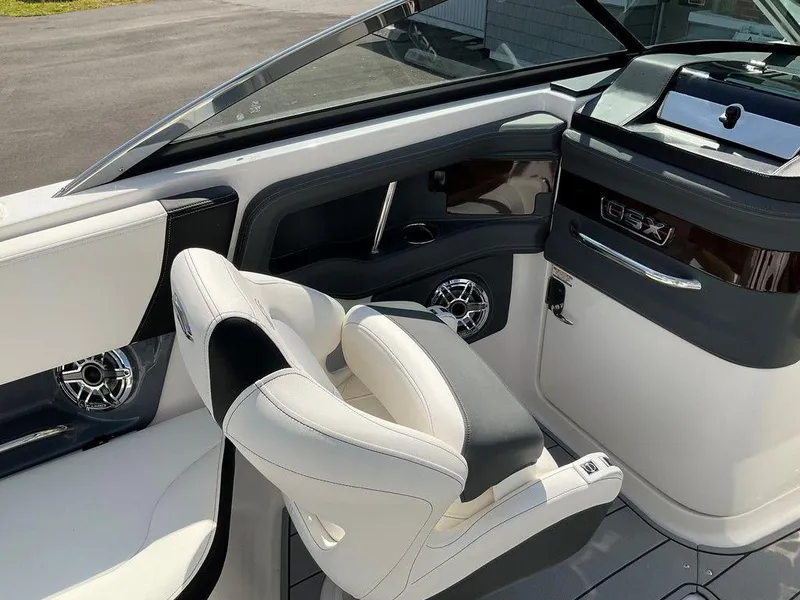 Slide: The Image of 2024 Chaparral 270 OSX boat interior with sleek seating and modern dashboard design. - 17