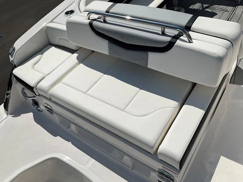 Slide: The Image of 2024 Chaparral 270 OSX boat with luxurious white seating and sleek design. - 22