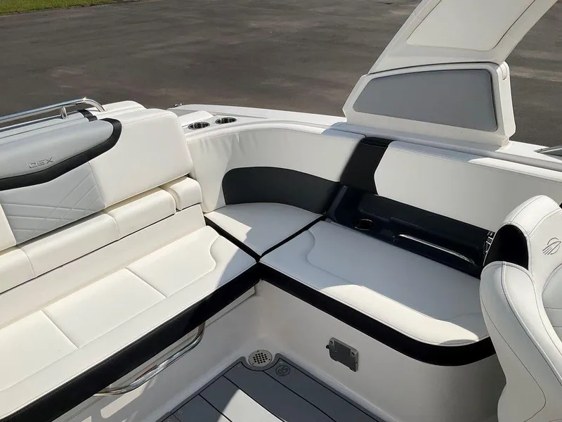 Slide: The Image of 2024 Chaparral 270 OSX boat interior with white and black seating. - 28