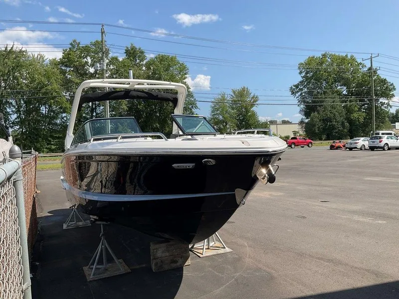 Slide: The Image of 2024 Chaparral 270 OSX boat on display in a parking lot. - 3