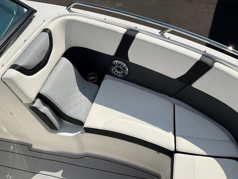 Slide: The Image of 2024 Chaparral 270 OSX boat interior with cushioned seating and speaker. - 38