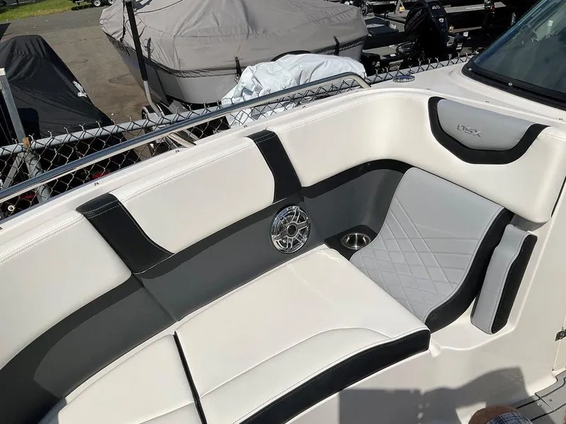 Slide: The Image of 2024 Chaparral 270 OSX boat interior with stylish seating and speaker detail. - 39