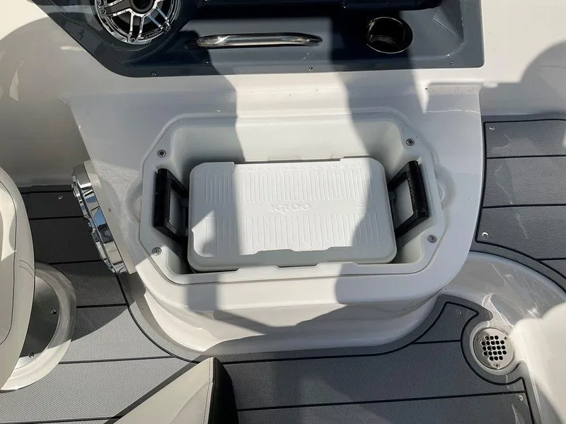Slide: The Image of 2024 Chaparral 270 OSX boat interior with built-in cooler and speaker. - 4