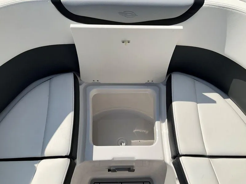 Slide: The Image of 2024 Chaparral 270 OSX boat interior with cushioned seating and storage compartment. - 41