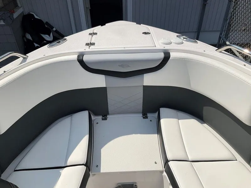 Slide: The Image of 2024 Chaparral 270 OSX boat interior with white and gray seating. - 42