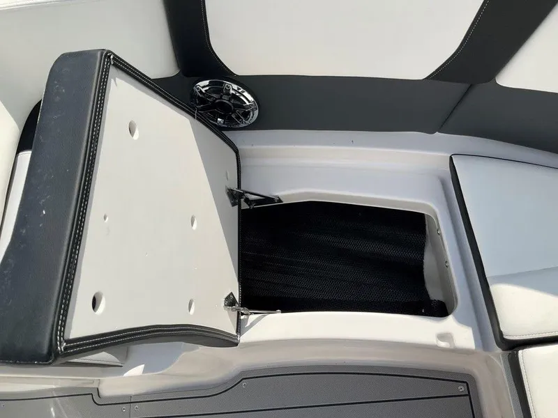 Slide: The Image of 2024 Chaparral 270 OSX boat storage compartment with open hatch and speaker. - 43