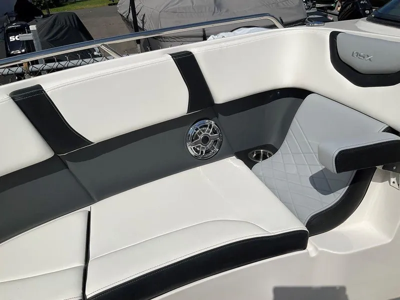 Slide: The Image of 2024 Chaparral 270 OSX boat interior with stylish seating and speaker detail. - 45