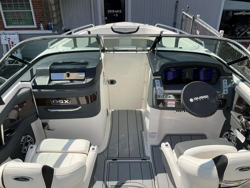 Slide: The Image of 2024 Chaparral 270 OSX boat interior with modern dashboard and seating. - 46