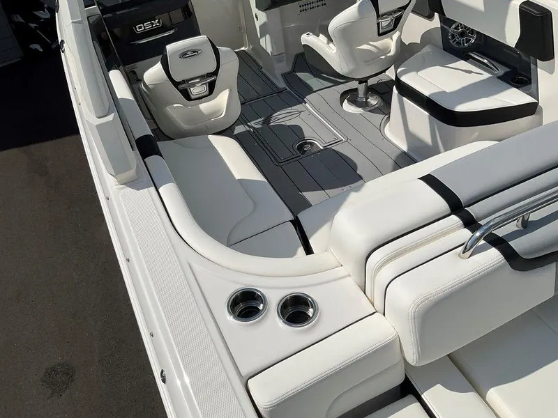 Slide: The Image of 2024 Chaparral 270 OSX boat interior with white seating and cup holders. - 7