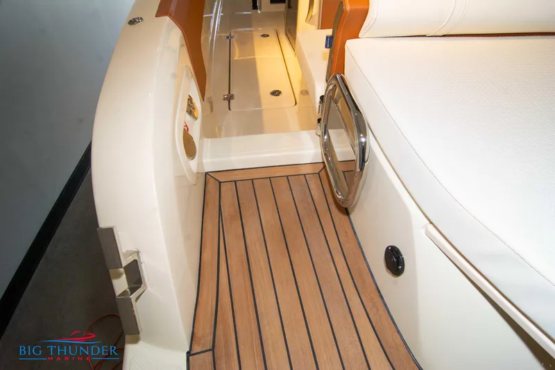 Slide: The Image of 2024 Capoforte SX280I boat interior with teak flooring and white seating. - 11