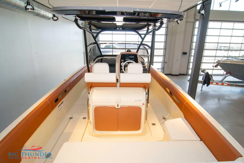 Slide: The Image of 2024 Capoforte SX280I boat interior with seating and console in showroom. - 14