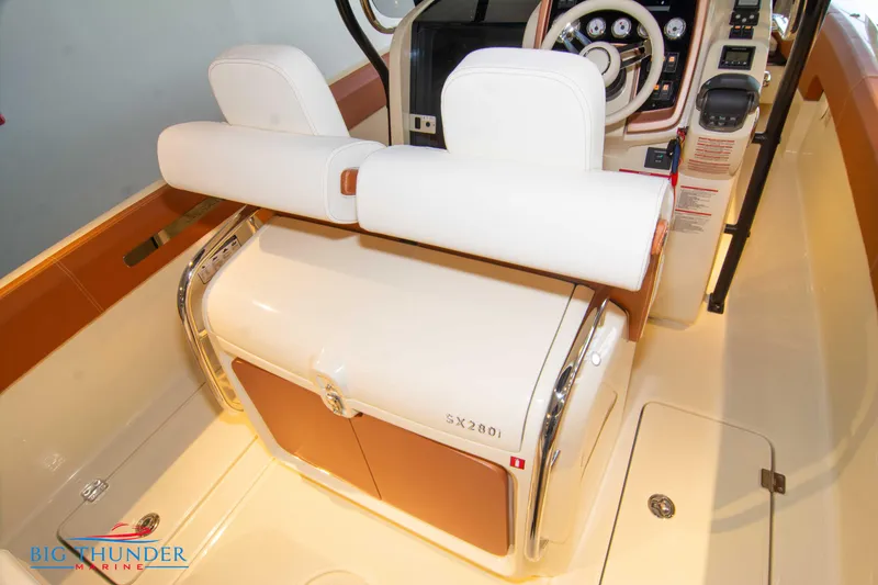 Slide: The Image of 2024 Capoforte SX280I boat interior with white and tan seating and dashboard. - 19