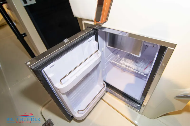 Slide: The Image of Open refrigerator on Capoforte SX280I 2024 boat, showcasing interior storage. - 22