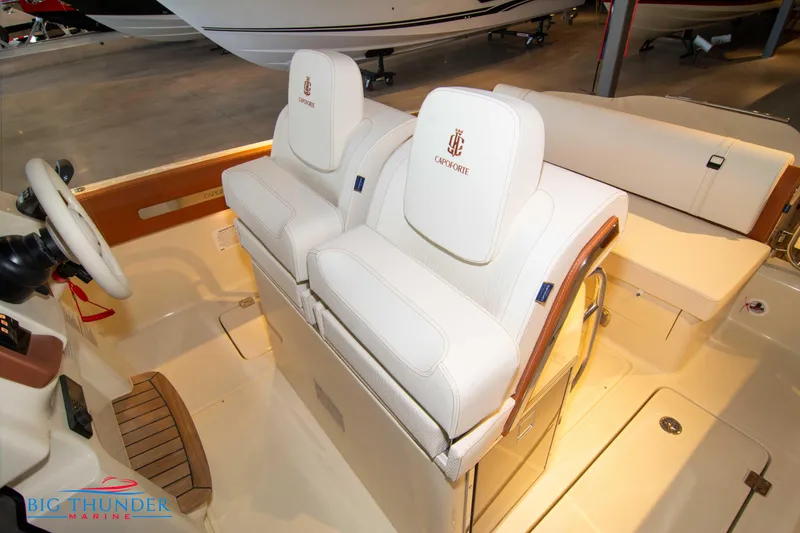 Slide: The Image of 2024 Capoforte SX280I boat interior with white leather seats and steering wheel. - 44