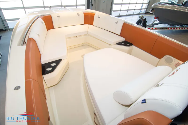 Slide: The Image of 2024 Capoforte SX280I boat interior with white and tan seating in showroom. - 49