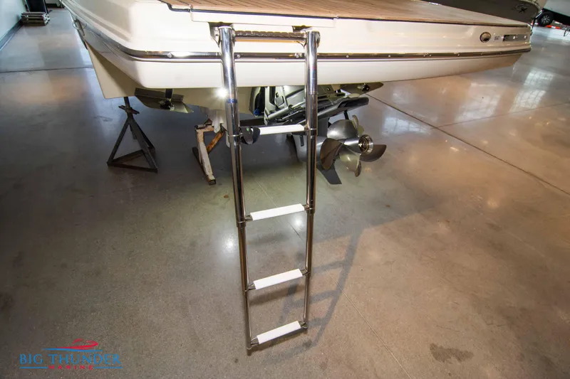 Slide: The Image of 2024 Capoforte SX280I boat with extended swim ladder and outboard motor. - 9
