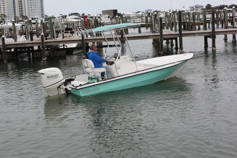 Slide: The Image of 2019 Wagner Catamaran Coaches boat in marina with Suzuki outboard motor. - 6