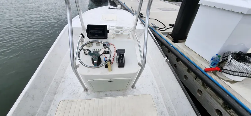 Slide: The Image of 2019 Wagner Catamaran Coaches boat console at dock with steering wheel and controls. - 9