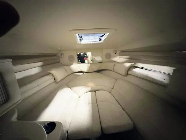 Slide: The Image of Interior cabin of a 2001 Sea Ray 260 Sundancer boat with cushioned seating. - 10