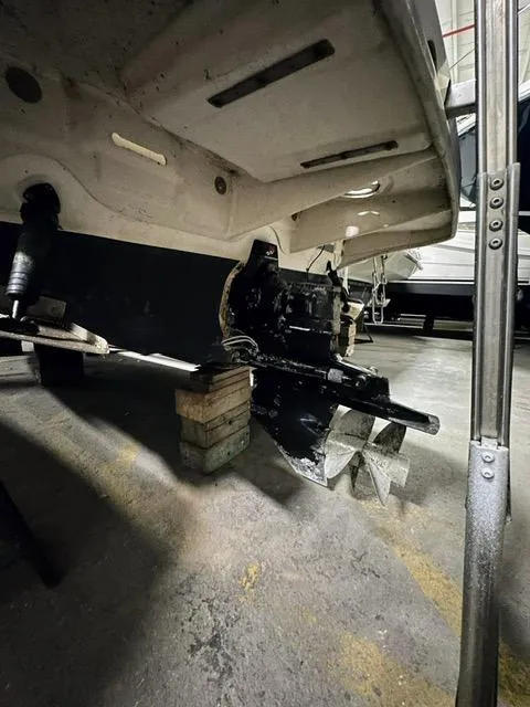 Slide: The Image of 2001 Sea Ray 260 Sundancer boat propeller and stern drive in a garage. - 12
