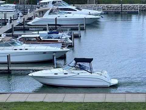 Slide: The Image of 2001 Sea Ray 260 Sundancer docked in a marina with other boats. - 14