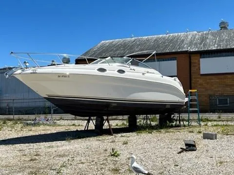 Slide: The Image of 2001 Sea Ray 260 Sundancer boat on dry dock near industrial buildings. - 16