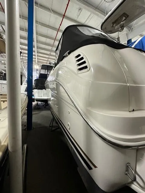 Slide: The Image of 2001 Sea Ray 260 Sundancer boat in indoor storage facility. - 2