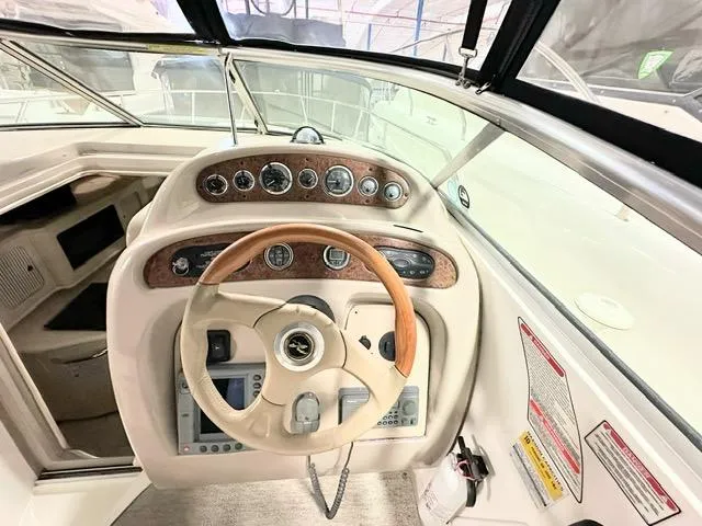 Slide: The Image of Cockpit view of 2001 Sea Ray 260 Sundancer with wooden steering wheel and instrument panel. - 6