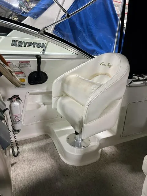 Slide: The Image of Captain's seat of a 2001 Sea Ray 260 Sundancer boat with steering wheel and controls. - 7
