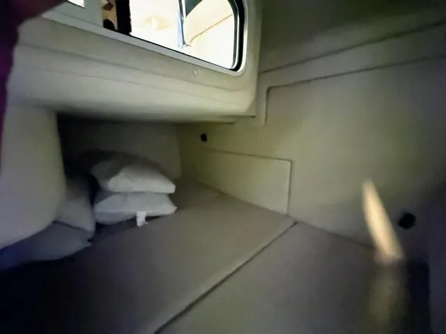 Slide: The Image of Interior cabin of a 2001 Sea Ray 260 Sundancer boat with cushions and pillows. - 8