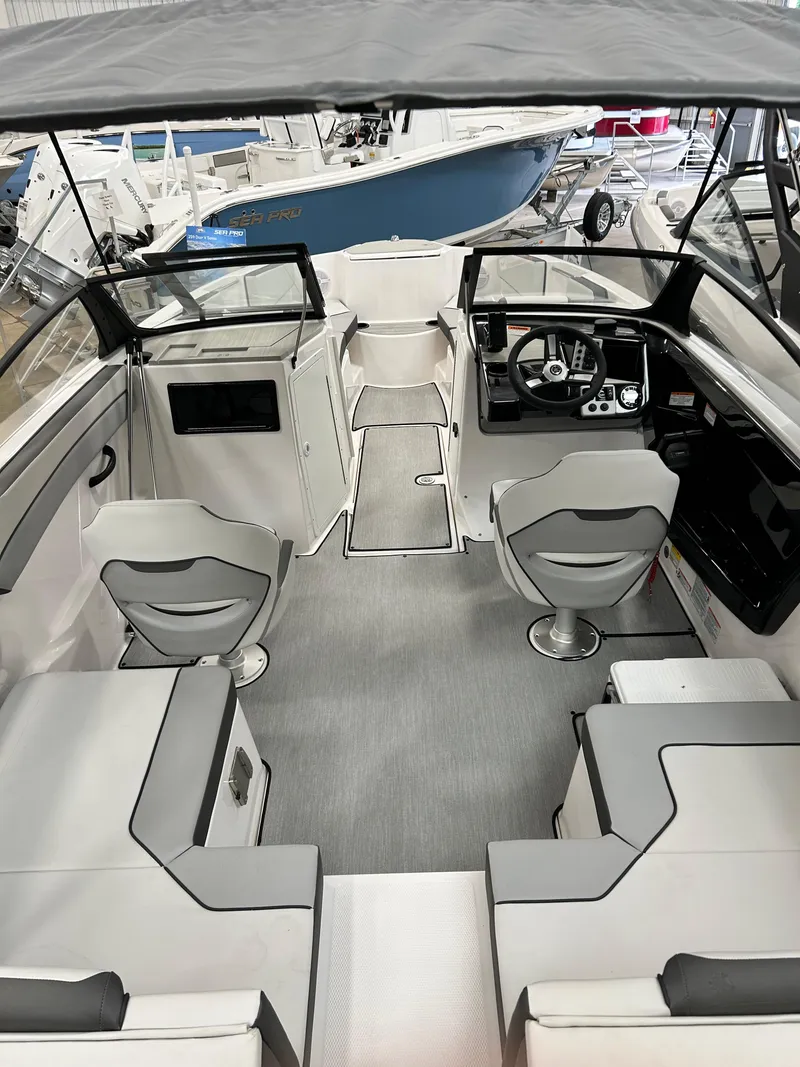 Slide: The Image of 2024 Yamaha Boats SX 220 interior with modern seating and control console. - 2