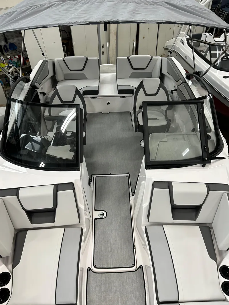 Slide: The Image of 2024 Yamaha Boats SX 220 interior with seating and canopy. - 6