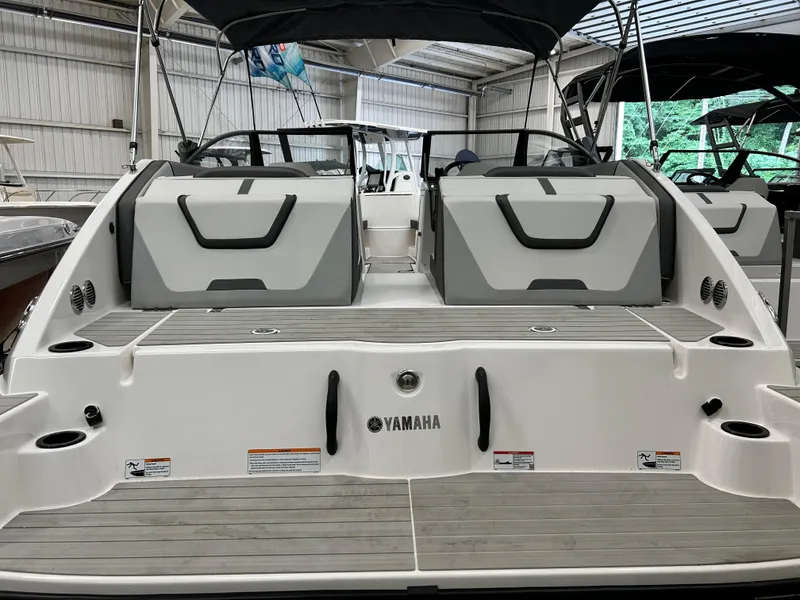 Slide: The Image of 2024 Yamaha Boats SX 220, rear view in a showroom. - 8
