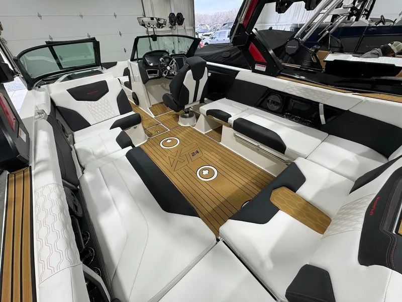 Slide: The Image of 2024 MasterCraft XT24 boat interior with luxurious seating and modern dashboard. - 16