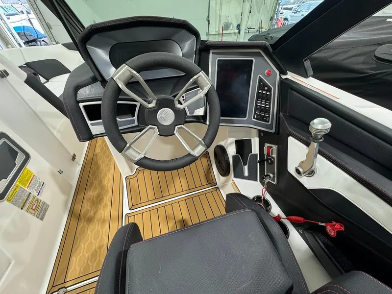 Slide: The Image of 2024 MasterCraft XT24 boat cockpit with modern steering wheel and control panel. - 18