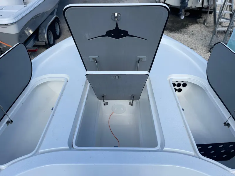 Slide: The Image of 2025 Turner Boatworks 2500 VS storage compartments open on deck. - 8