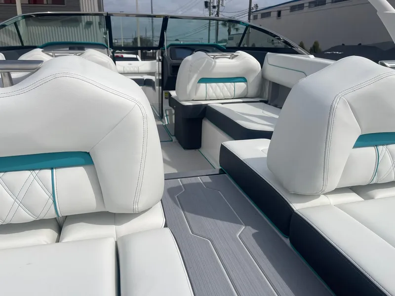 Slide: The Image of 2024 Regal LS4 boat interior with white and teal seating. - 11