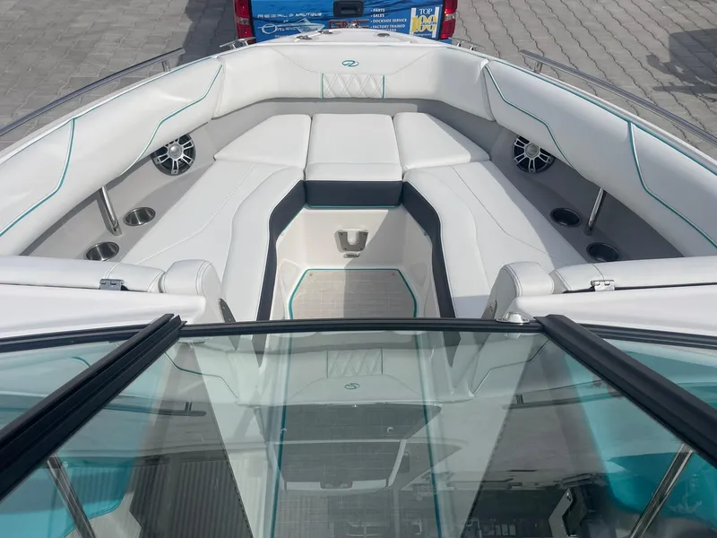 Slide: The Image of 2024 Regal LS4 boat interior with white seating and cup holders. - 7